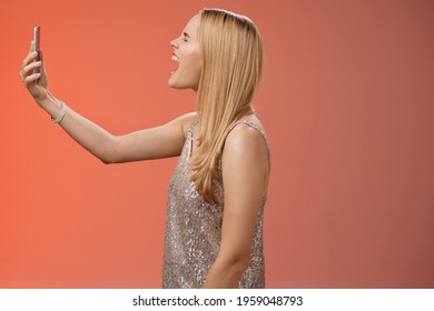 Profile Shot Funny Carefree Blond Woman Hold Smartphone Raised Open Mouth Wide Yelling Recording Video Own Shout Scream, Standing Silver Glamour Dress Near Red Background Fool Around