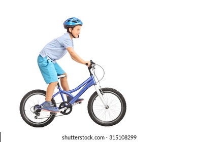 Profile Shot Of A Little Boy With Blue Helmet Riding A Small Blue Bike Isolated On White Background