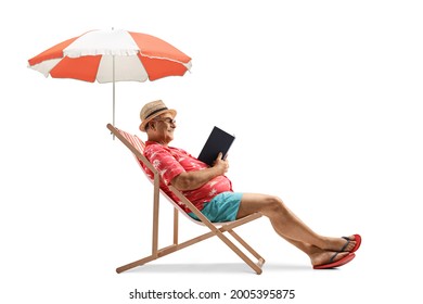 Profile Shot Of A Mature Male Tourist Reading A Book Under Umbrella Isolated On White Background