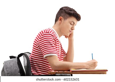 Profile shot of a teenage student sitting in a chair and taking notes isolated on white background