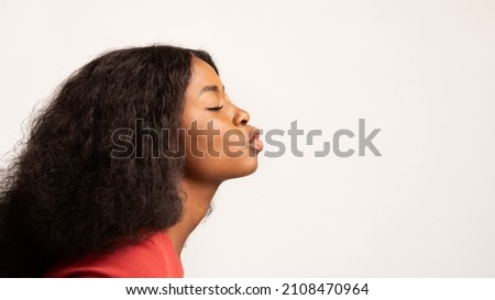 Profile Shot Of Young Black Woman Pouting Lips Over White Studio Background, Romantic Millennial African American Female Standing With Eyes Closed, Ready For Kiss, Side View, Panorama With Copy Space