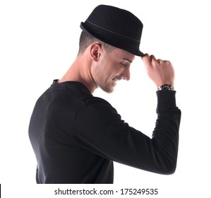 Profile Shot Of Young Man Smiling, Touching Fedora Hat On His Head, Isolated On White