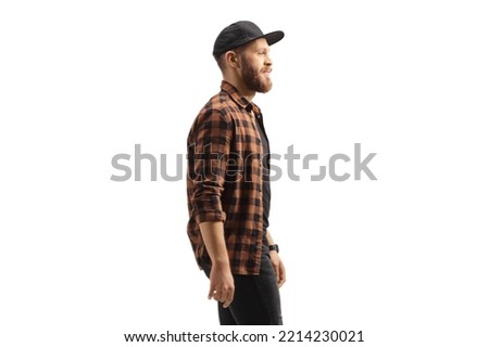 Profile shot of a young trendy man in a shirt and cap isolated on white background