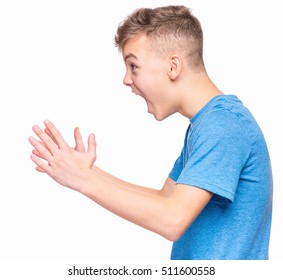 Profile of the shouting boy - emotional portrait of caucasian teen boy wearing blue t-shirt. Furious teenager screaming with mouth wide open. Handsome child shouting out loud, isolated on white