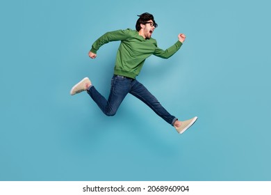 Profile side full body photo of happy crazy man running in air traveling wear glasses isolated on blue color background - Shutterstock ID 2068960904