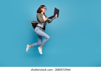 Profile Side Full Size Photo Of Excited Lady Ceo Jump Chatting Netbook Ap Wear Denim Isolated Over Blue Color Background