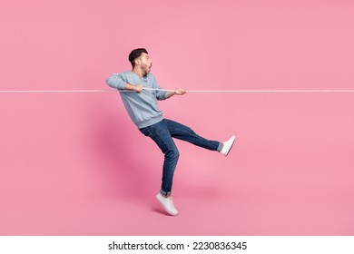 Profile side full size photo of impressed guy pull string see incredible huge bargain isolated on pastel color background