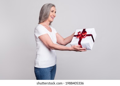 Profile Side Photo Of Aged Woman Happy Positive Smile Give Present Gift Box Party Isolated Over Grey Color Background