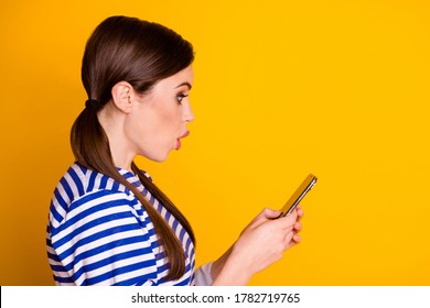 Profile side photo of astonished girl use cellphone impressed read social media corona virus pandemic information wear good look clothes isolated shine color background
