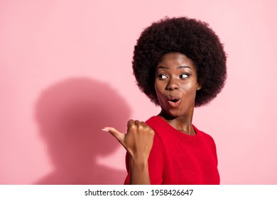 Profile side photo of brunette afro american girl point empty space wear red jumper shock isolated on pink color background