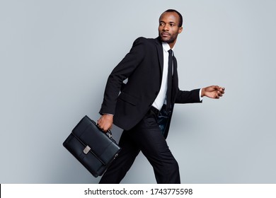 Profile Side Photo Of Busy Masculine Afro American Broker Agent Man Go Walk Hold Handbag Hurry For Business Partnership Meeting Wear Black Blazer Jacket Isolated Over Gray Color Background