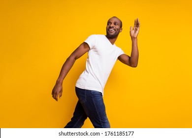 Profile Side Photo Of Charming Cheerful Candid Afro American Guy Go Spring Walk Wave Hand Say Good Bye Wear Trendy Clothes Isolated Over Shine Color Background