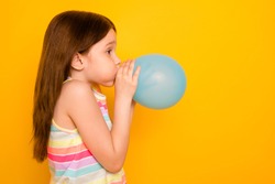 Profile Side Photo Of Charming Kid Inflating Baloon Isolated Over Yellow Background