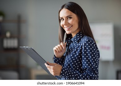 Profile side photo of cheerful happy young business woman new idea hold clipboard make plan in office workplace
