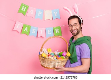 Profile Side Photo Of Good Mood Cute Man With Bunny Ears Hold Easter Basket Celebrate Holiday Isolated On Pink Color Background