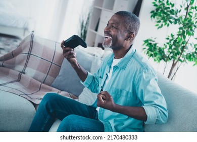 Profile side photo of good mood overjoyed male addicted to cybersport playing video games using playstation