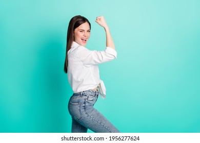 Profile Side Photo Of Happy Strong Young Woman Show Biceps Hand Winner Isolated On Pastel Teal Color Background