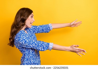 Profile side photo of positive cheerful lady wear blue clothes meet friend look empty space isolated on yellow color background - Shutterstock ID 2256235031