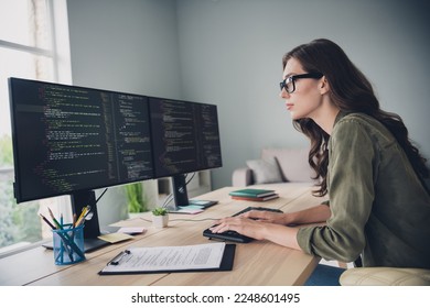 Profile side photo of smart focused lady developing site download content install new server reboot operating system indoor workstation - Powered by Shutterstock