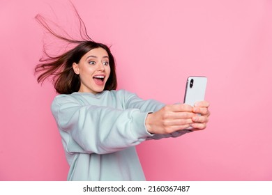 Profile side photo of young excited lady have fun make selfie vlogger isolated over pink color background - Shutterstock ID 2160367487