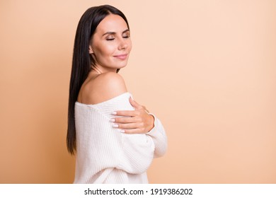 Profile side photo of young girl happy enjoy embrace herself dream dreamy comfort cozy isolated over beige color background