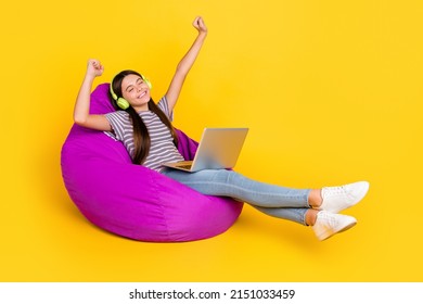 Profile Side Photo Of Young Girl Have Fun Listen Music Headphones Melody Sit Soft Purple Chair Isolated Over Yellow Color Background