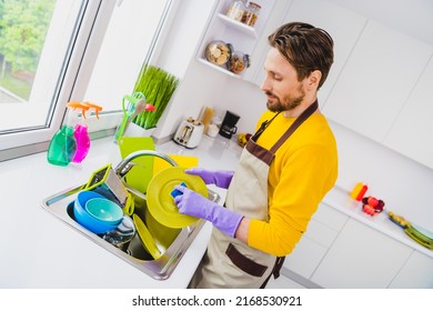 Profile Side Photo Of Young Handsome Man Wear Apron Good Mood Cleaning Wash Dishes Sink Kitchen Duty Indoors