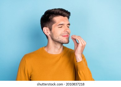 Profile side photo of young man happy positive smile show finger perfect tasty great sign chef isolated over blue color background - Shutterstock ID 2010837218