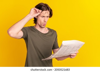 Profile side photo of young man amazed shocked look read newspaper fake novelty isolated over yellow color background
