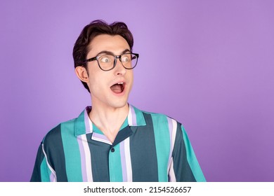 Profile side photo of young man astonished crazy look empty space fake news isolated over violet color background