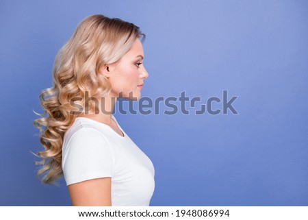 Profile side photo of young serious charming beautiful lovely pretty girl look copyspace isolated on blue color background