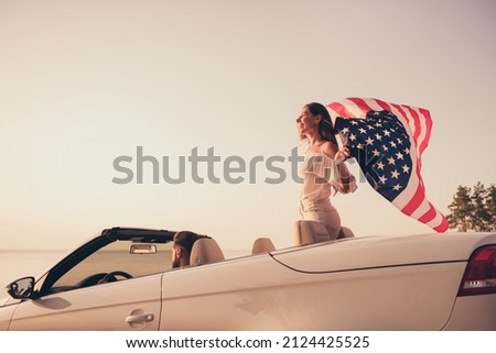 Profile side photo of young woman keeping american flag cabriolet transport seaside enjoy journey abroad outdoors