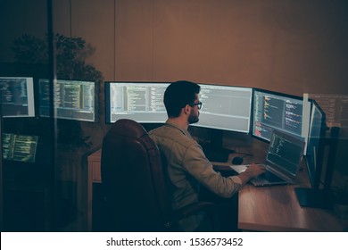 Profile side view of his he nice attractive serious qualified smart clever bearded brunet guy geek nerd making bug report tracking seo web blockchain ai linux in dark beige room work place station