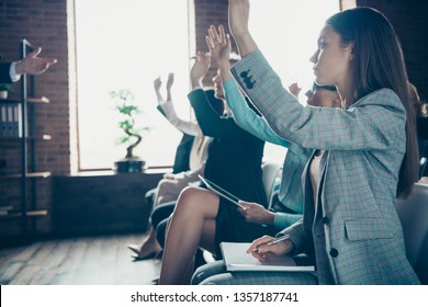 Profile side view of nice attractive stylish cheerful ladies attending educative forum listening top manager start-up project rising hands up industrial loft interior work place space indoors