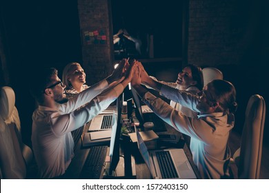 Profile Side View Of Nice Attractive Cheerful Cheery Glad Successful Coworkers Gathering Developing Company Celebrating Clapping Palms At Night At Workplace Station Dark Room