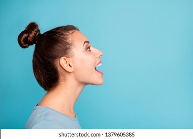 Profile side view photo of pretty youngster glad content enjoy shout news open mouth look up ads wear modern millennial pullover beautiful spring isolated on blue background