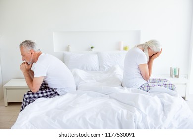 Profile Side View Photo Of Sad Lovers After Quarrel Fight. Man And Cry Woman With Gray Hair Sit Back-to-back On The Linen, Sheets Edge Of The Bed Quarreled, Did Not Talk