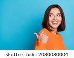 Profile side view portrait of attractive cheerful girl demonstrating copy space ad new isolated over bright blue color background