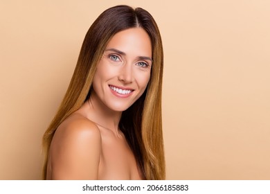 Profile side view portrait of attractive cheerful woman with fresh skin tone copy space advert isolated over beige pastel color background