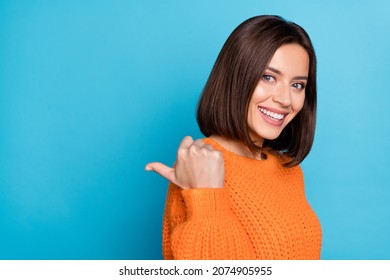 Profile side view portrait of attractive cheerful girl demonstrating copy empty space isolated over bright blue color background