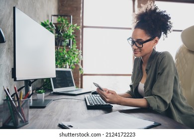 Profile side view portrait of attractive focused girl technician texting using device app remote support at workplace workstation indoors