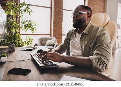 Profile Side View Portrait Of Attractive Focused Guy Expert Typing Remote Technical Support At Workplace Workstation Indoors