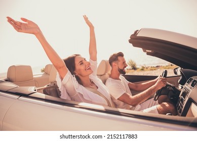 Profile side view portrait of attractive adorable carefree cheerful couple riding car having fun free time outdoors