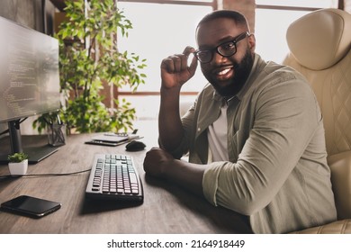 Profile side view portrait of attractive cheery guy director tech leader touching specs at workplace workstation indoors