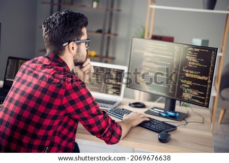 Profile side view portrait of attractive skilled focused guy writing html code css language php at work place station indoors