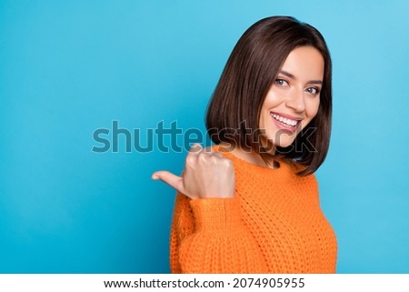 Profile side view portrait of attractive cheerful girl demonstrating copy empty space isolated over bright blue color background