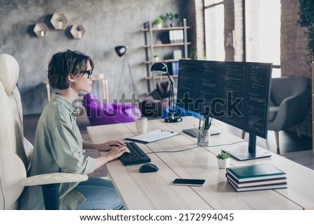 Profile side view portrait of attractive skilled girl support manager typing text code html operating css at work place station indoors
