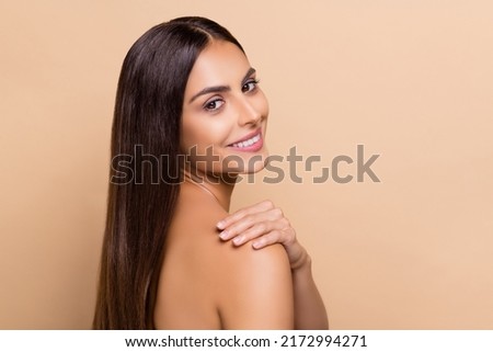 Profile side view portrait of attractive cheery girl washing pure flawless skin balm isolated over beige pastel color background