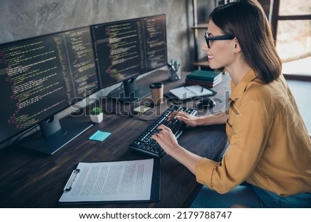 Profile side view portrait of attractive cheery girl editing source html debugging modify at workplace workstation indoors
