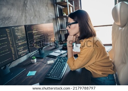 Profile side view portrait of attractive clever focused girl cyber engineer analyzing html process service at workplace workstation indoors